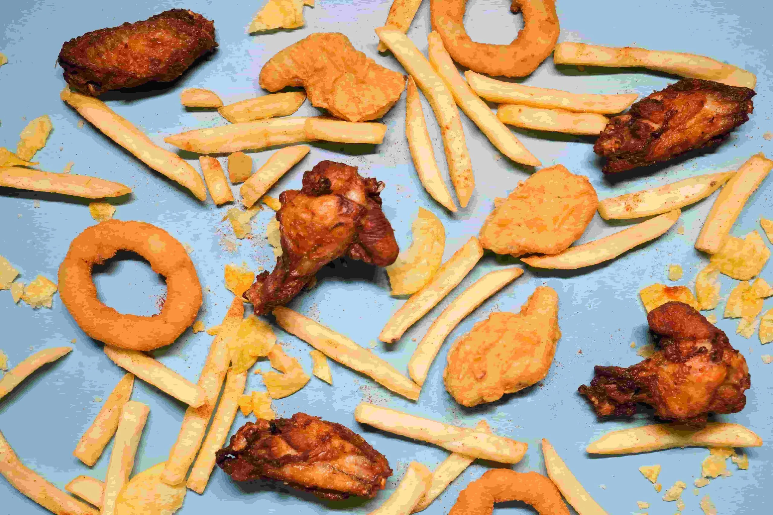 What are ultra-processed foods, including chips, cookies, instant noodles, sugary drinks, burgers, and packaged snacks.